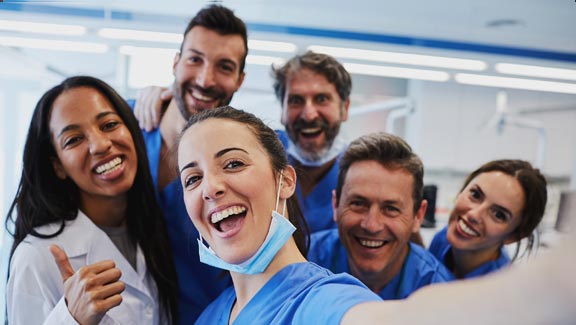 A group of happy dental practitioners in a Dentist's office.